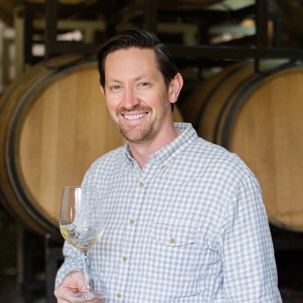 Portrait of Palmer Emmitt in wine cellar