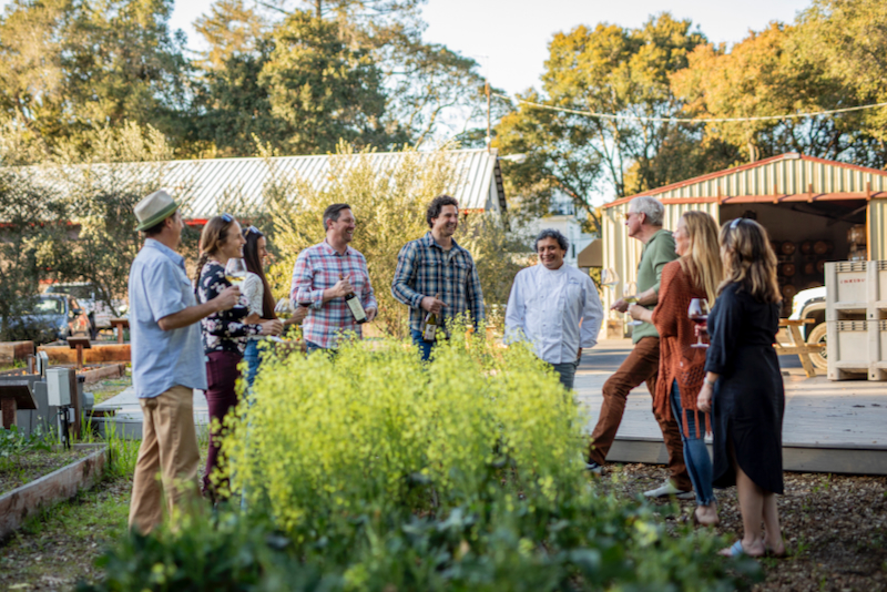 Owner-winemakers Michael Scorsone and Palmer Emmitt entertain guests in their winery garden along with Chef Mateo Granados